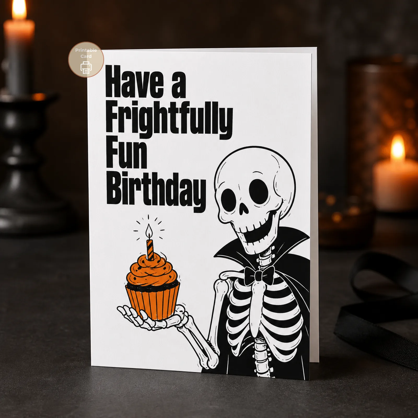 Styled product mockup: Make their birthday deliciously spooky with a frightfully fun skeleton serving an orange cupcake in bold gothic style.