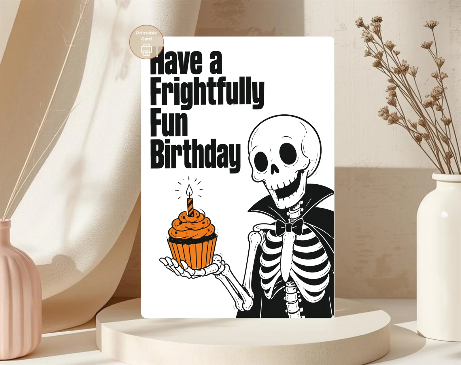 Printing and file-use instructions supplied with the Make their birthday deliciously spooky with a frightfully fun skeleton serving an orange cupcake in bold gothic style. digital download.