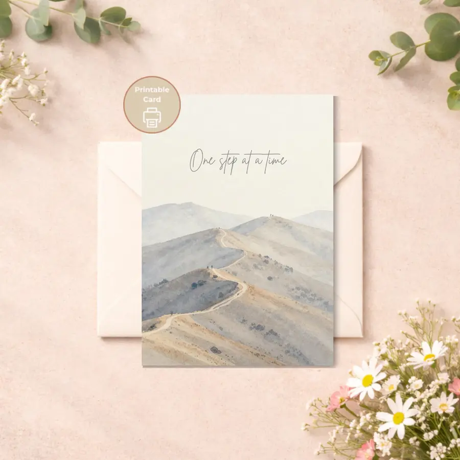 Styled product mockup: A soft and calming printable encouragement card featuring a peaceful mountain landscape and the gentle phrase One step at a time.