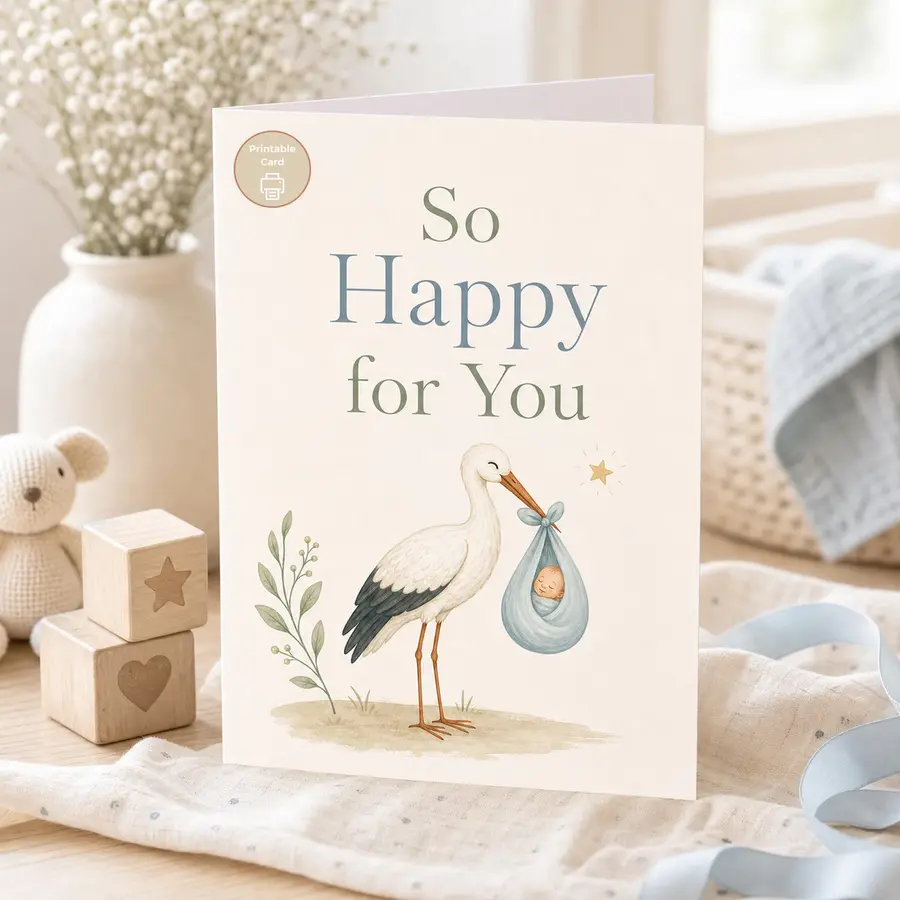 Styled product mockup: This new baby printable card features a sweet stork carrying a tiny blue bundle with the message So Happy for You.