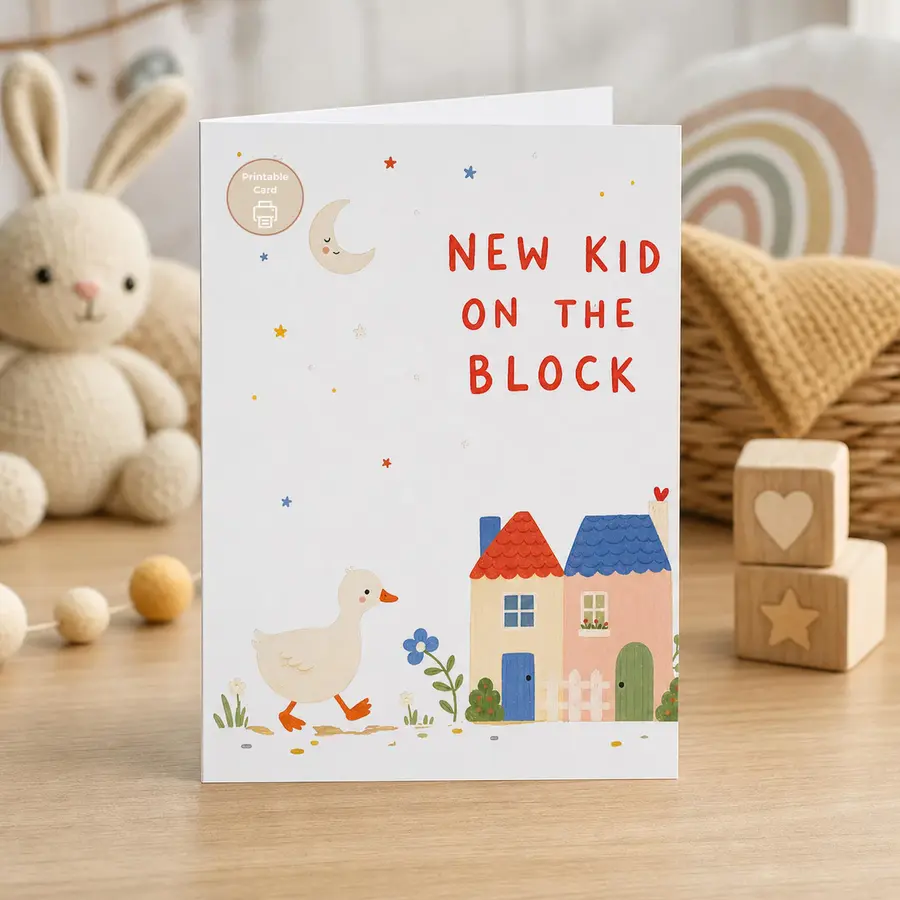 Styled product mockup: Celebrate a new arrival with a playful watercolor card featuring a little duck, cozy houses, moon and stars, and the cheerful phrase New Kid On The Block.
